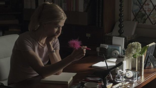 Girl interrupted: Rosamund Pike as Amy considers one of her diary entries in <i>Gone Girl</i>.