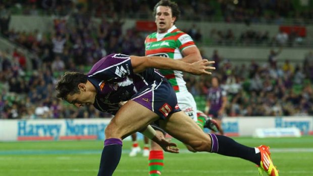 Magic man ... Billy Slater crosses for one of his two tries against Souths in Melbourne last night. His side won 24-10 to be undefeated after two rounds.