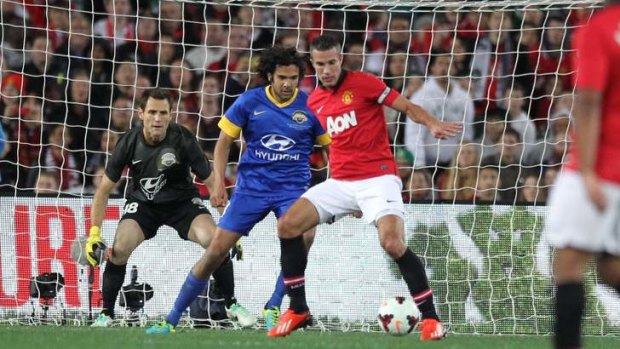 Devil of a time: Manchester United superstar Robin van Persie holds off the All Stars' defence in last year's match.