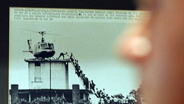 People look at the famous image by Hugh Van Es which is showing at the Foreign Correspondents' Club in Hong Kong. It became one of the most enduring images from the Vietnam war.