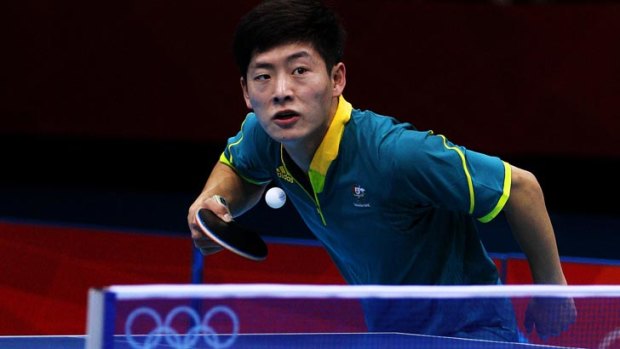 Justin Han of Australia serves against Mawussi Agbetoglo of Togo during their men's singles preliminary round match on day of table tennis competition at the London Olympics.