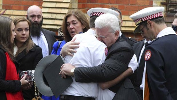 Emotional farewell: Robert Rossington is given his son Paul's hat at a memorial service.