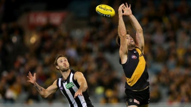 Trent Cotchin attempts to take a mark as Brent Macaffer watches keenly.