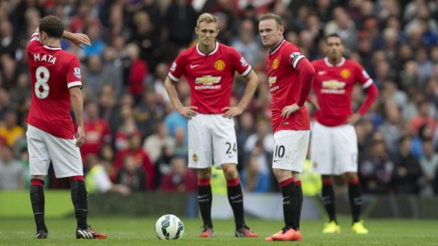 Shocked Manchester United players after the opening round loss.