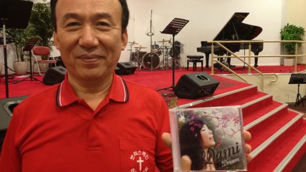 Pastor Joseph Hong holds a CD Dami recorded for the Brisbane Full Gospel Church in Eight Mile Plains.