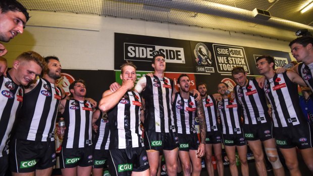 First game: Mason Cox (centre) celebrates with his Magpie teammates after their big win on Anzac Day.