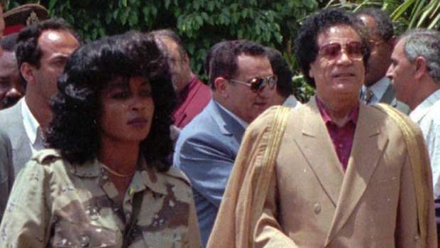 Libyan leader Colonel Gaddafi with one of his female bodyguards.