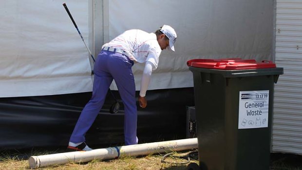 Wasted day &#8230; Chinese teenager Guan Tianlang retrieves his ball during a horror round on Thursday.