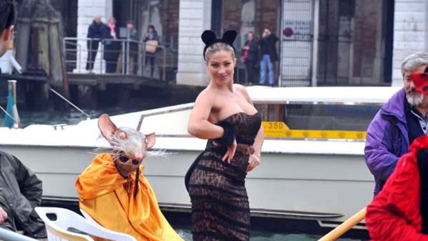Vittoria Risi, a Venezian porn star, and members of Venessia.com,  a group of campaigners for the defence of the city of Venice, parade in gondolas during the protest.