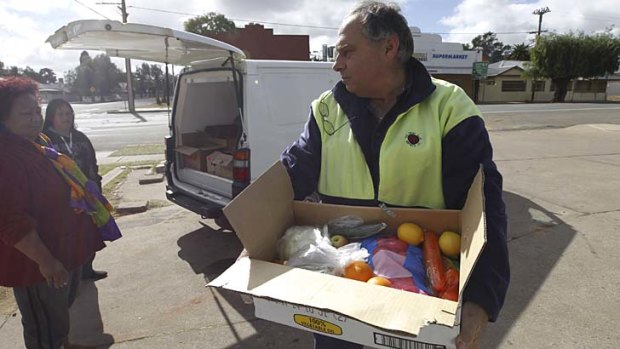 Livio Djakovic, from the Barrier Social Democratic Club, with food for the people of Wilcannia.