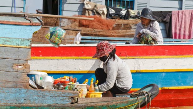 Enterprising ... vendors selling from a boat in a  floating village   near Siem Reap, Cambodia.