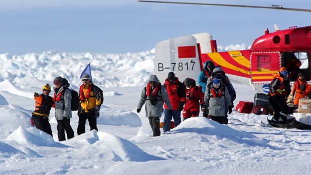 The first load of passengers rescued from the ship Akademik Shokalskiy in Antarctica are delivered by Chinese helicopter to an ice floe next to the Aurora Australis icebreaker.