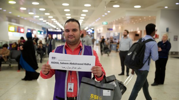 Adam Bujairami, a "welcome-to-Australia" official, awaits the Ridha family, from Iraq, at Sydney International Airport.
