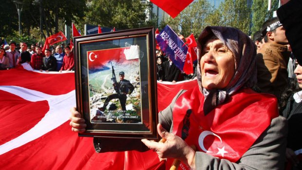 Yeter Eroglu holds a photograph of her son, Murat, killed by Kurdish rebels.