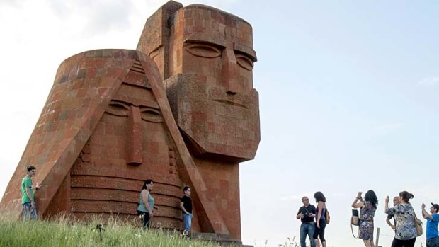 Tourists visit the Grandmother and Granfather monument outside city of Stepanakert in Armenian-controlled Azerbaijani region of Nagorny Karabakh.