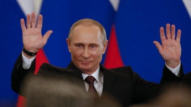 Show of strength: Vladimir Putin triumphant after signing treaty to take back Crimea.