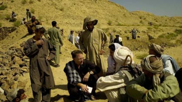 On the job... David Rohde, with notepad in hand, interviews Afghans in Helmand province in 2007.