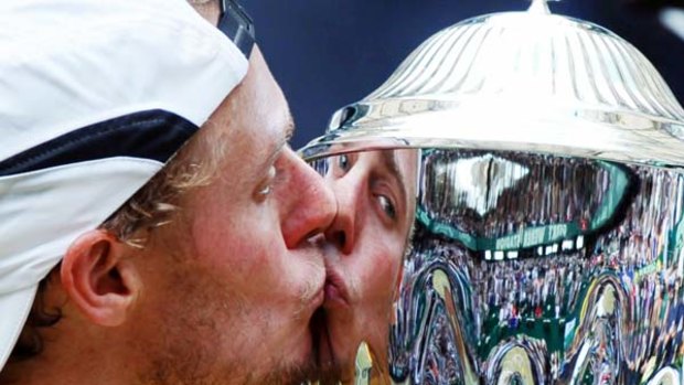 Halle and hearty ... Lleyton Hewitt kisses the trophy after winning the Gerry Weber Open in Halle, Germany, with a victory over Roger Federer.