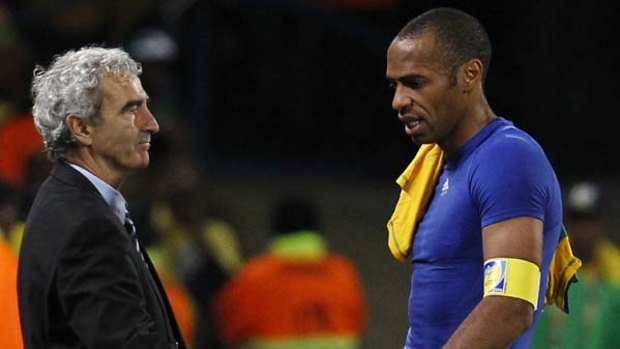 Thierry Henry, right, shakes hands with coach Raymond Domenech as he leaves the pitch after France's loss to South Africa.
