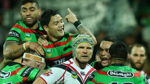 Odd man out: Warrior Todd Lowrie can’t look as Souths celebrate another try.