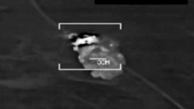 An image from a handout video released by the US Central Command showing a US jet strike on what the US says is an ISIL target in northern Iraq.