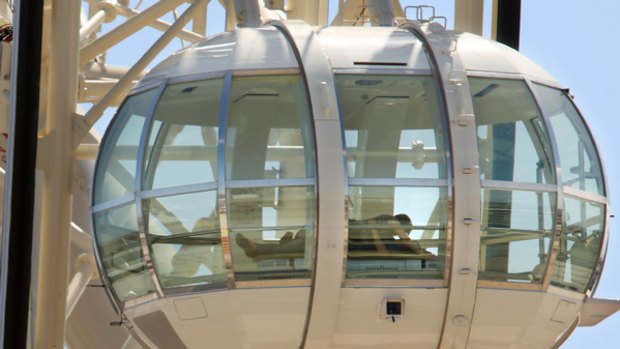 A couple gets amorous in one of the Southern Star's glass carriages last week. "I suppose it had to happen," said the observation wheel's chairman, Fred Maybury.