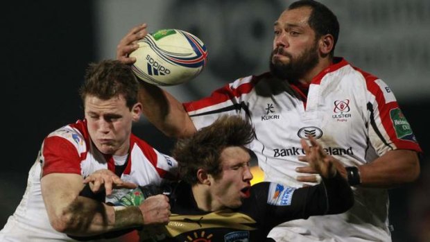 Ulster's John Afoa (right)and Craig Gilroy (left) fend an attempted tackle from Montpellier's Yohan Artru.