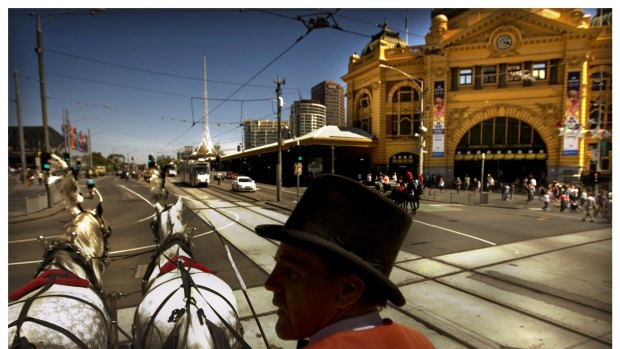 A horse-drawn carriage passes one of Melbourne's best-known landmarks.