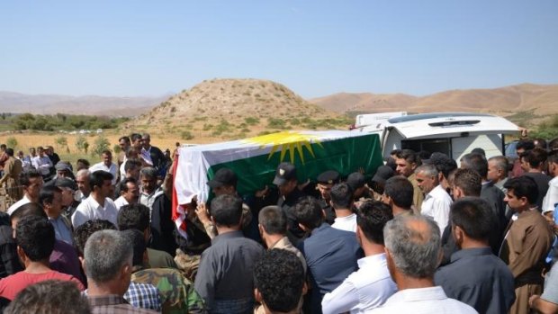Casualty of war: Mourners carry the coffin of a Kurdish fighter in Iraq's Sulaimaniya province.