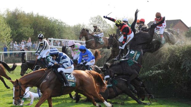 Several horses fall at Becher's Brook during the Grand National.