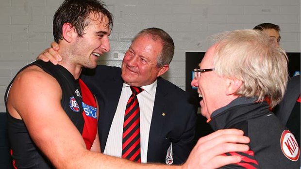 Well done: Jobe Watson is congratulated by board member Greg Brown (centre) and Essendon doctor Bruce Reid.
