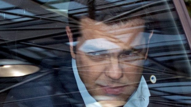 Greek Prime Minister Alexis Tsipras arrives in his car at the eurozone leaders' summit in Brussels.