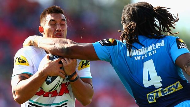 Outclassed: Titans centre Jamal Idris tackles Panthers fullback Dean Whare at Centrebet Stadium on Saturday.