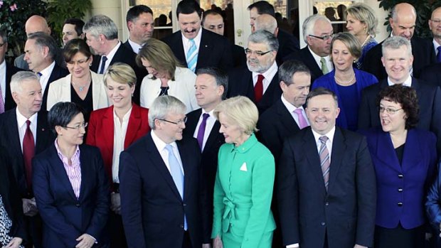 Prime Minister Kevin Rudd, surrounded by his new ministry, talks to Governor-General Quentin Bryce.