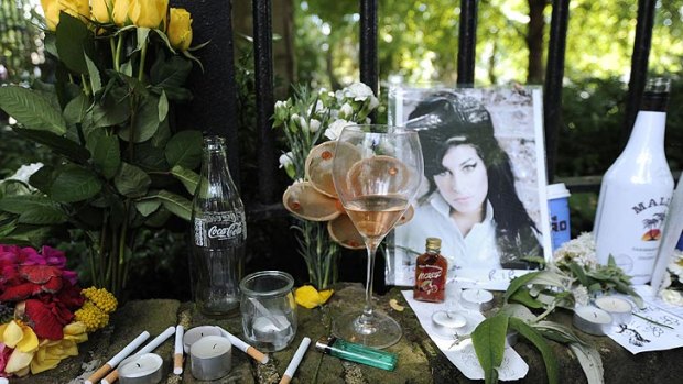 Booze and cigarettes ... Tributes to Amy Winehouse outside her London flat.