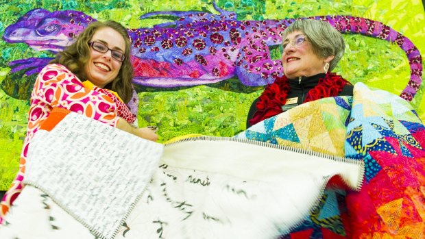 Canberra Quilters' member Gemma Jackson and president Helen Rose get ready for the quilt show.