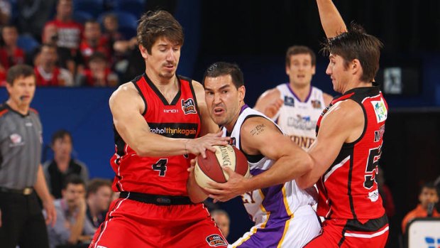 Kings guard Luke Martin is trapped by the Wildcats defence during Sydney's heavy loss in Perth.