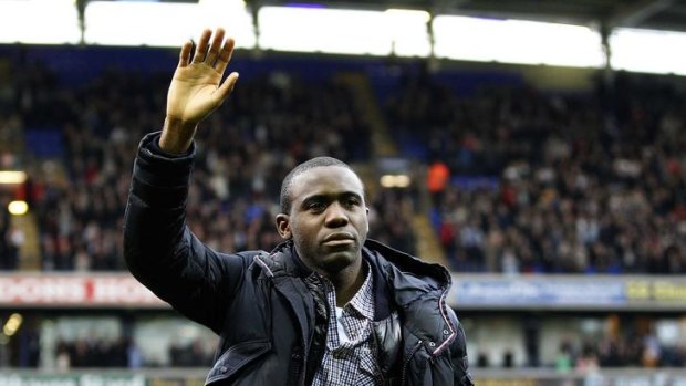 Emotional return ... Bolton's Fabrice Muamba waves to the crowd.