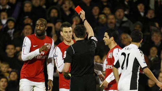 Seeing red: Arsenal's Johan Djourou is shown the red card and sent off by referee Lee Probert.