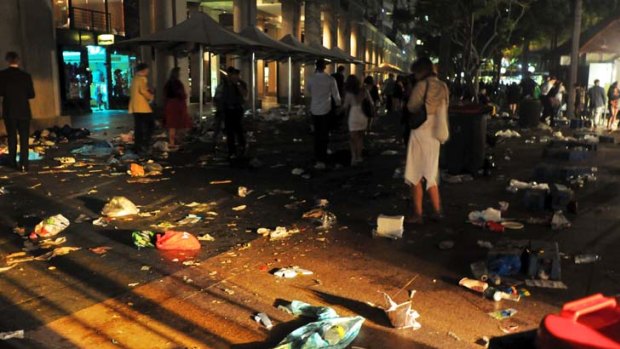 East Circular Quay strewn with litter after the midnight fireworks display and the last of the crowd leaves for home.