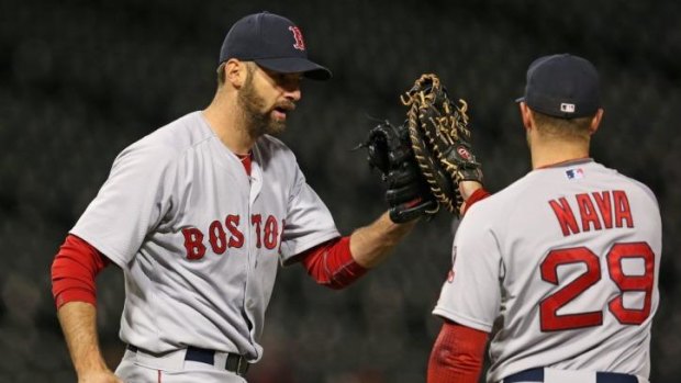 The Boston Red Sox's Burke Badenhop and Daniel Nava celebrate their marathon win.