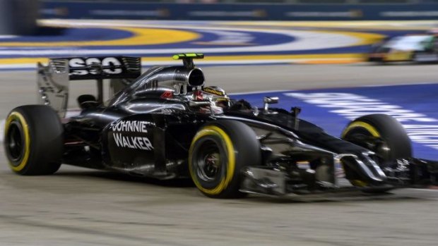 Burning up: Magnussen in his McLaren Mercedes during the Singapore Grand Prix.