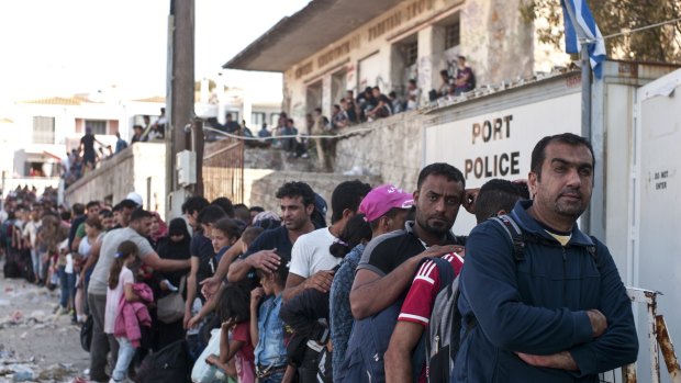 Refugees line up as they wait to register on the north-eastern Greek island of Lesbos.