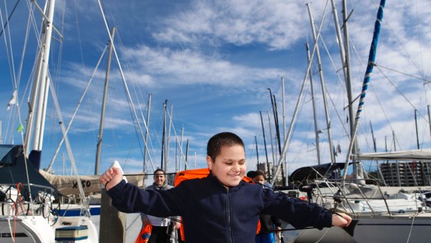 Member of the group Sailors with DisABILITIES Khan Cawaitakali plays among boats as the group prepares to sail to northern NSW.