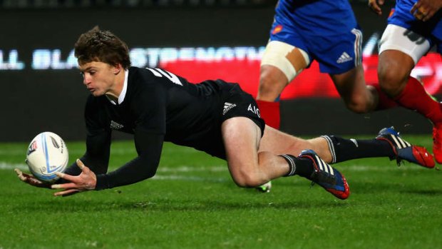 Beauden Barrett of the All Blacks collects the loose ball to score a try.