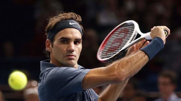 Roger Federer in action against Philipp Kohlschreiber of Germany at the Paris Masters men's singles tennis tournament.