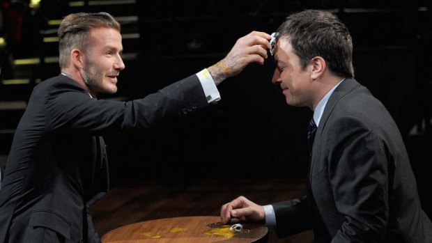 Crack up: Jimmy Fallon, left, plays 'Egg Russian Roulette' with football star David Beckham.