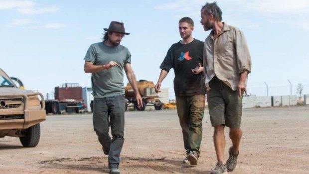 On set: From left, director David Michod, Robert Pattinson and Guy Pearce during filming of <i>The Rover</i>.