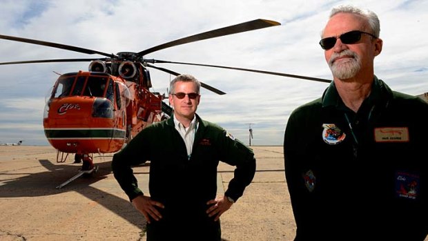 Pilots Andy Thomas (left) and Paul Kearns at Essendon airport for the arrival of the firefighting helicopter Elvis.