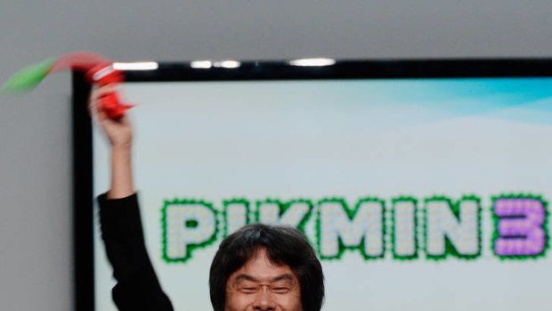 Nintendo producer Shigeru Miyamoto, who created Super Mario Bros, waves a Pikmin 3 video game character during a Wii U promotion at E3.